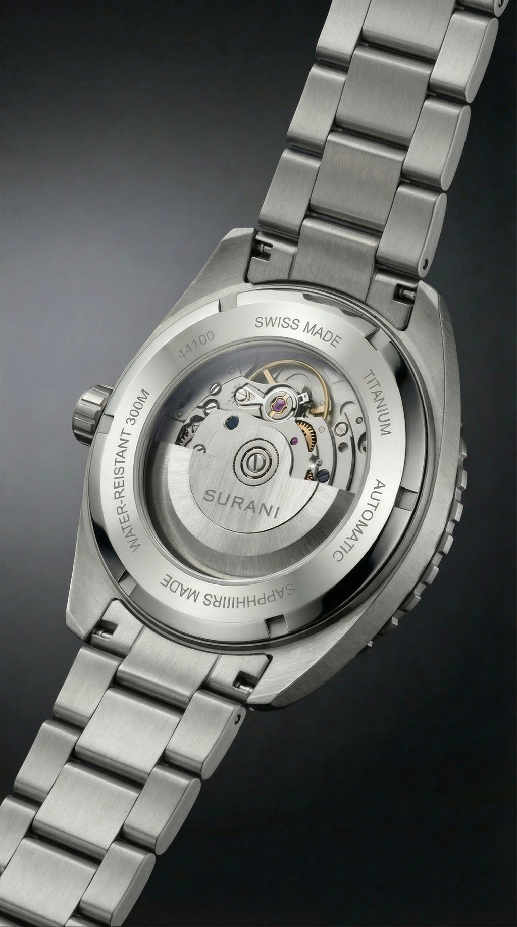 Silver watch with visible brand name on a dark background
