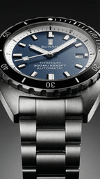 Suran watch with blue dial and metallic band on a dark background